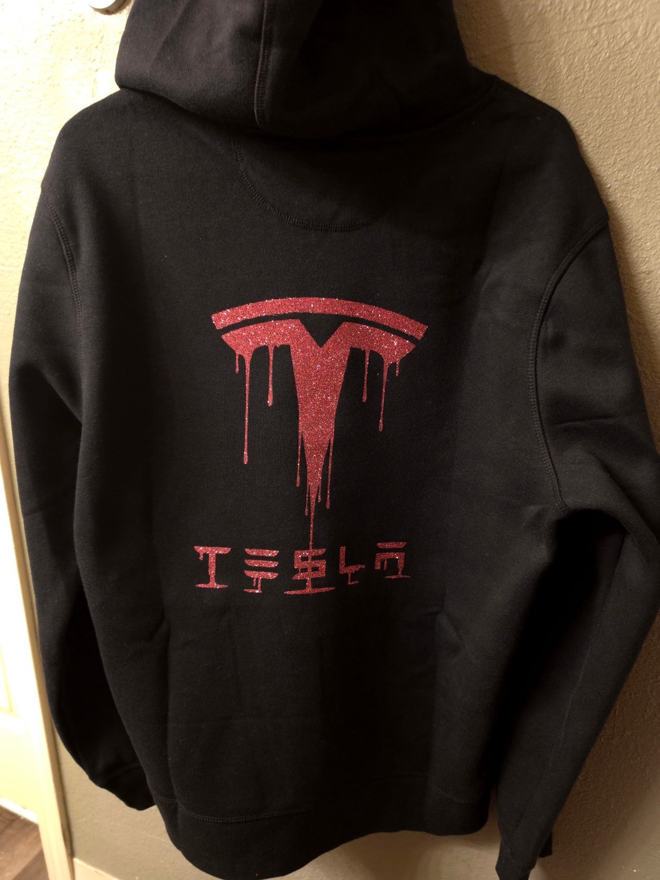 Black custom hoodie with a sparkling red graphic