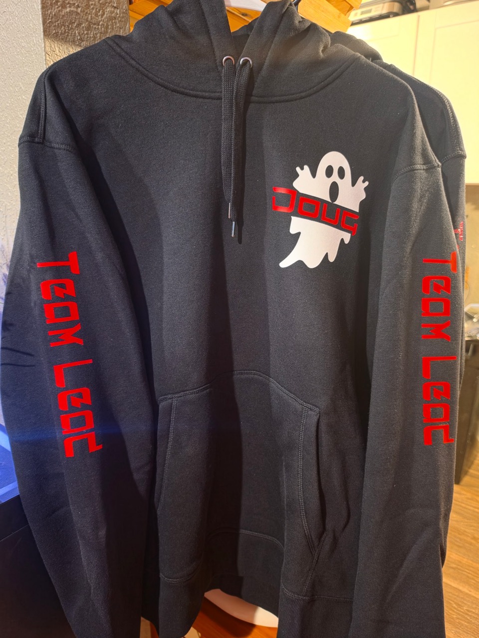 Black custom team hoodie with a white ghost and red lettering